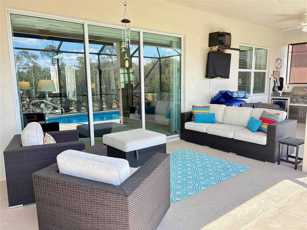 6261 Pinehurst Loop Winter Haven, FL 33884 - Photo 59 of 76 a living room with furniture and a floor to ceiling window