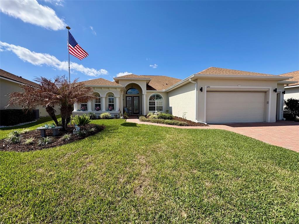 6261 Pinehurst Loop Winter Haven, FL 33884 - Photo 6 of 76 a front view of a house with a yard
