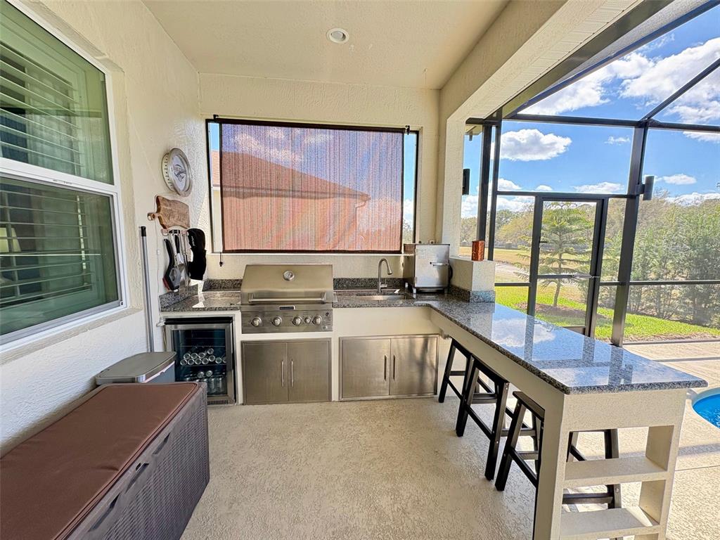 6261 Pinehurst Loop Winter Haven, FL 33884 - Photo 62 of 76 a kitchen with a stove a sink and a refrigerator