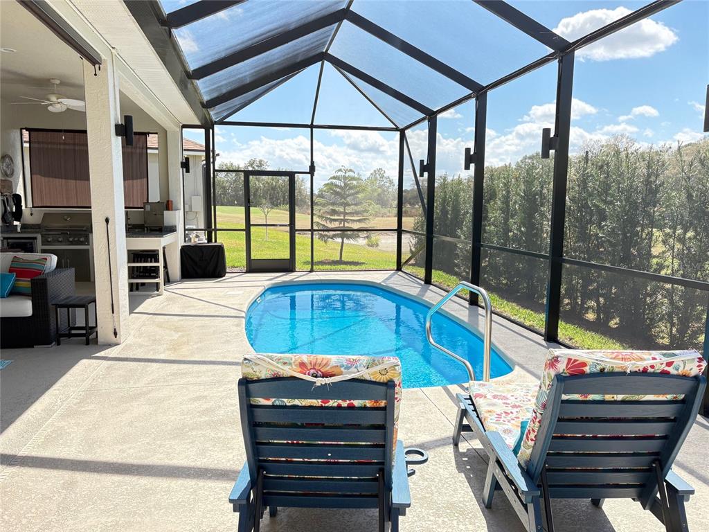 6261 Pinehurst Loop Winter Haven, FL 33884 - Photo 67 of 76 a view of a patio with a table chairs and a barbeque