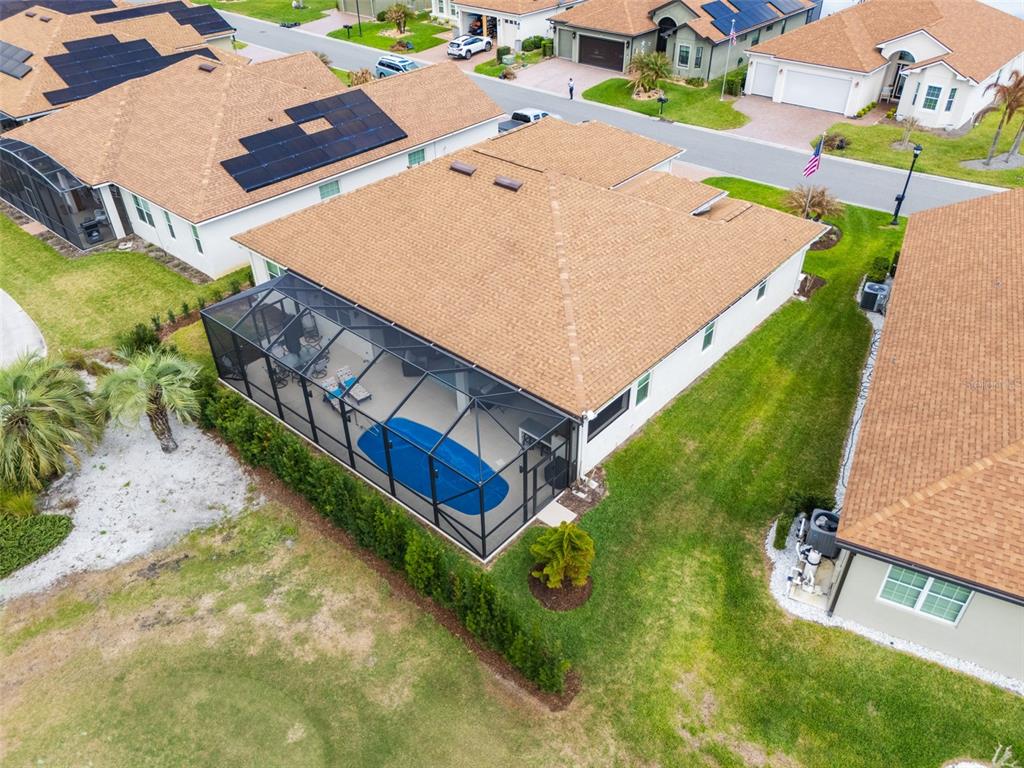 6261 Pinehurst Loop Winter Haven, FL 33884 - Photo 71 of 76 an aerial view of a house with swimming pool and large trees