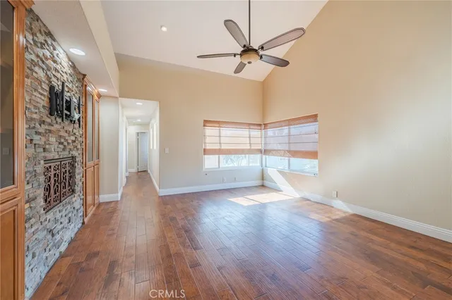 a bathroom with a granite countertop sink a toilet a mirror and shower