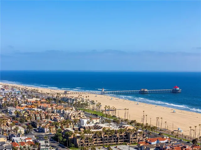 a view of a house with a palm tree and a porch