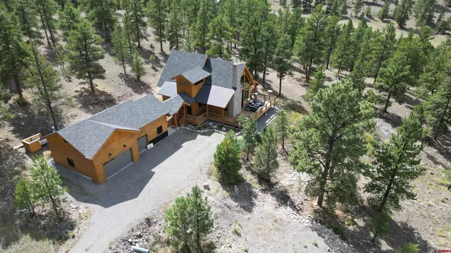 an aerial view of a house with a yard and lake view