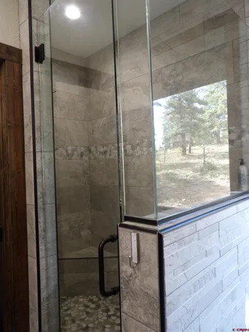 a bathroom with a glass shower door