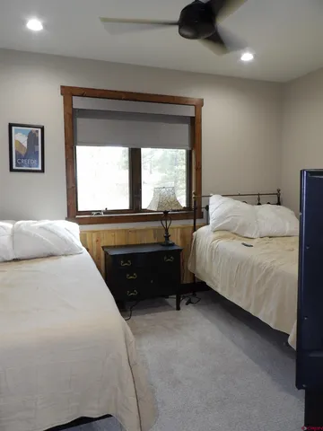 a bedroom with a bed and a large window