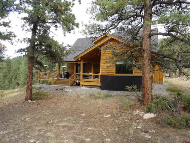 a view of a house with a yard covered in snow