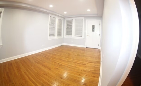 2435 North Rutherford Avenue Chicago, IL 60707 - Photo 4 of 5 a view of an empty room with wooden floor and a window