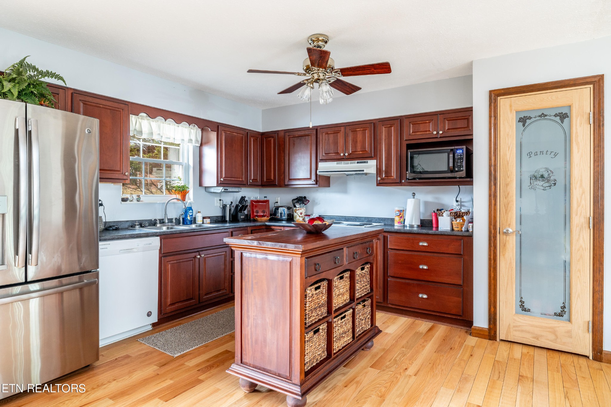 625 Riverbend Road Clinton, TN 37716 - Photo 19 of 45 a kitchen with stainless steel appliances granite countertop a refrigerator a stove a sink dishwasher and a refrigerator with wooden floor