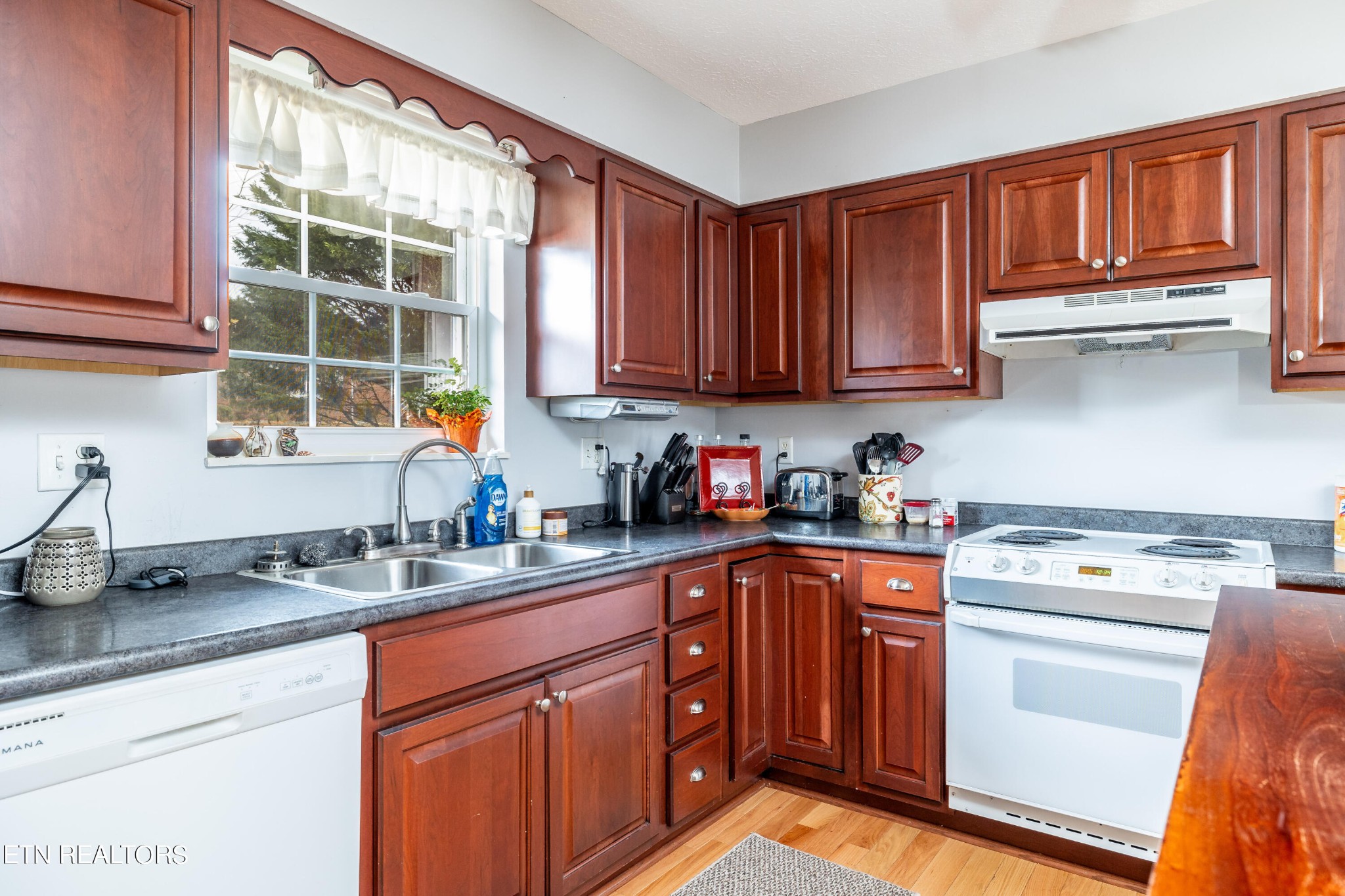 625 Riverbend Road Clinton, TN 37716 - Photo 20 of 45 a kitchen with stainless steel appliances granite countertop a sink stove and cabinets