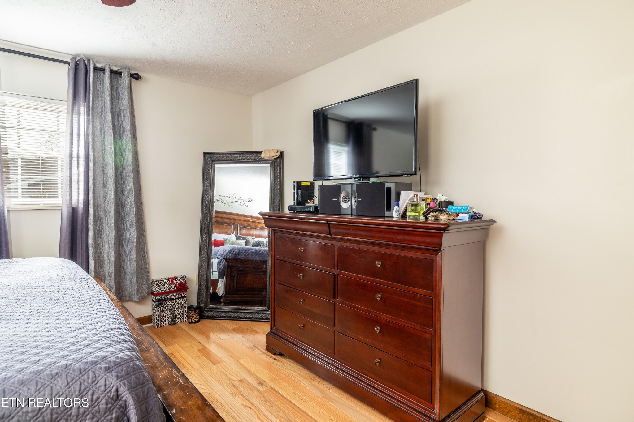 625 Riverbend Road Clinton, TN 37716 - Photo 31 of 45 a bedroom with a bed and a flat tv screen on dresser