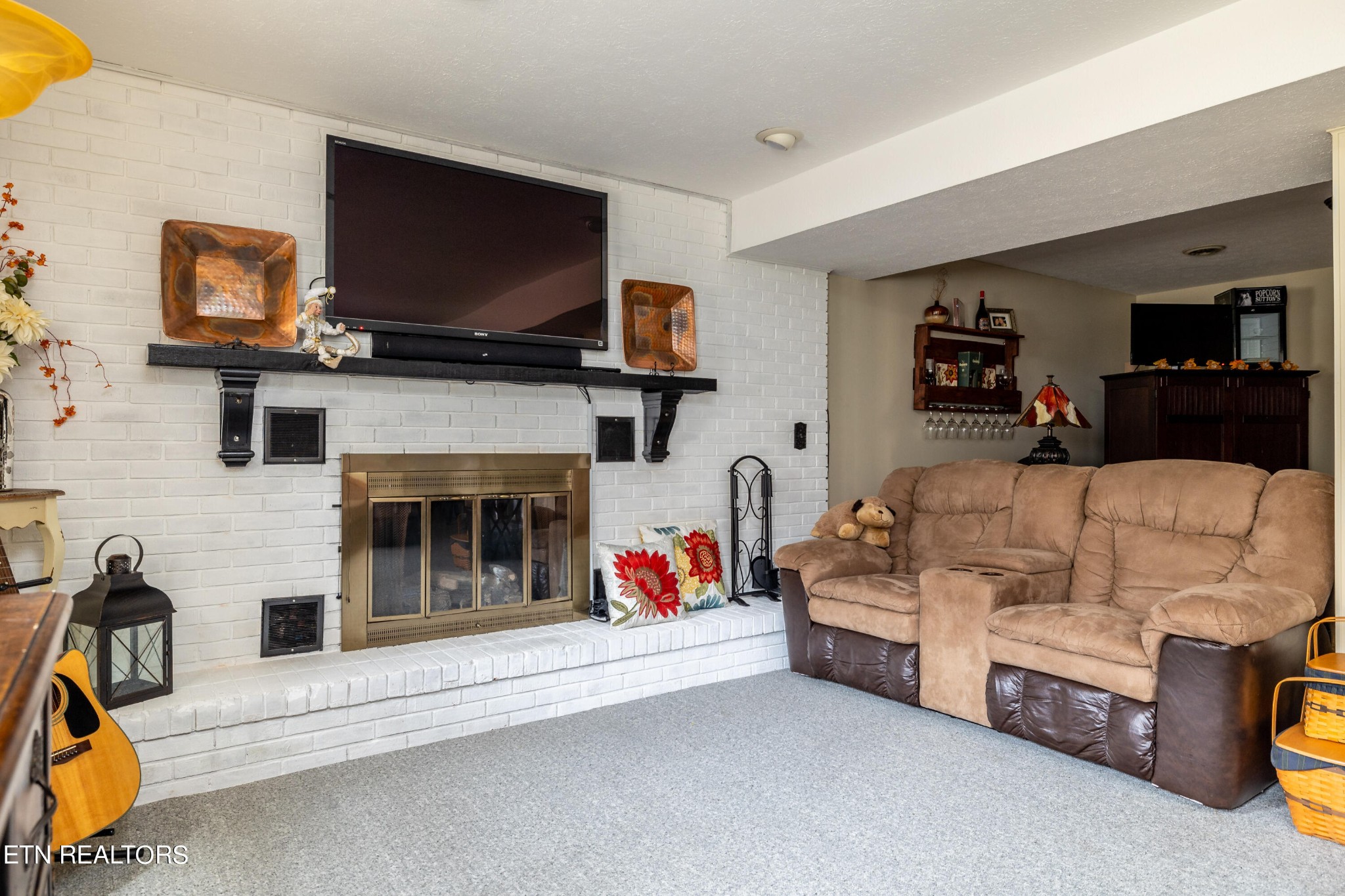 625 Riverbend Road Clinton, TN 37716 - Photo 35 of 45 a living room with furniture a flat screen tv and a fireplace