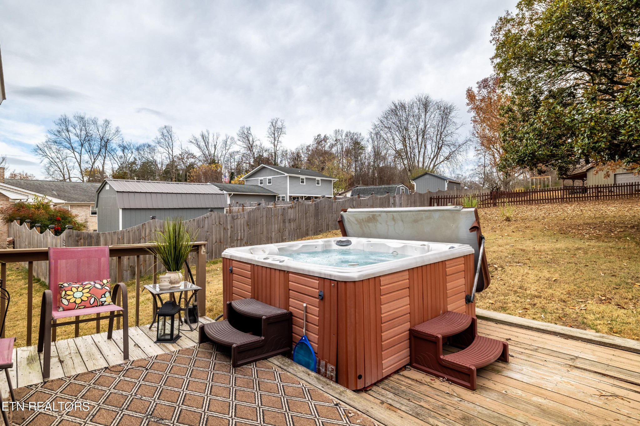 625 Riverbend Road Clinton, TN 37716 - Photo 8 of 45 a view of a patio with table and chairs with wooden floor and fence