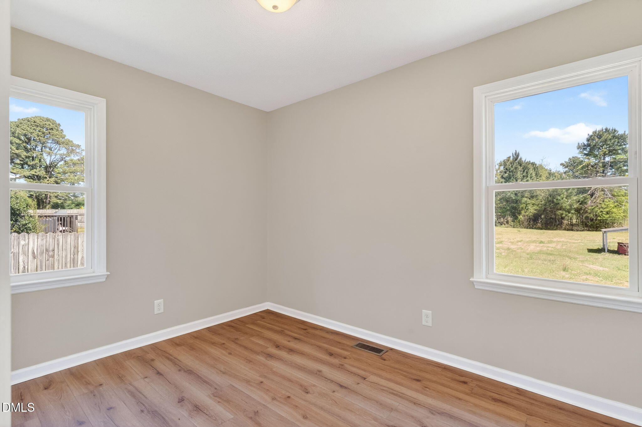 6086 Red Hill Church Road Coats, NC 27521 - Photo 16 of 44 an empty room with wooden floor and windows