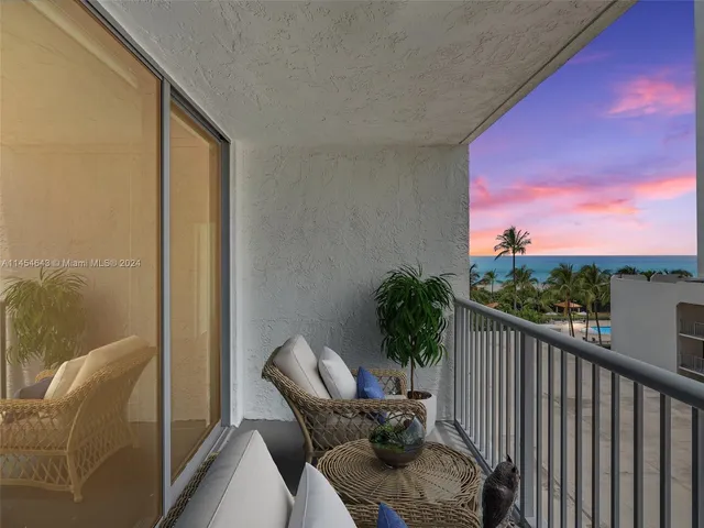 a balcony with furniture and a potted plant