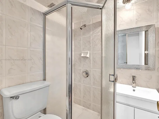 a kitchen with stainless steel appliances granite countertop a sink a stove and refrigerator