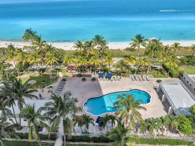 a view of a swimming pool with an outdoor space and seating area