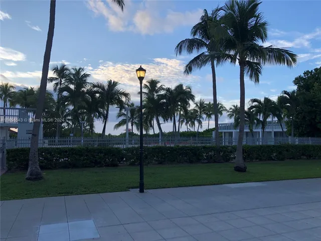 a room with lots of furniture and view of kitchen
