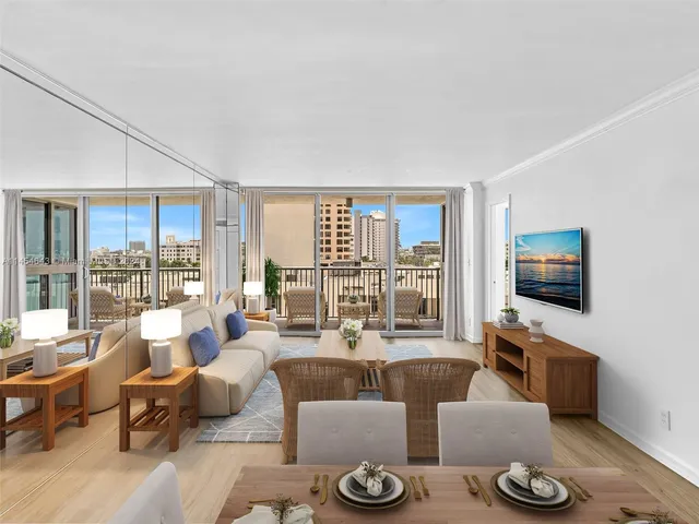 a living room with furniture a flat screen tv and large windows