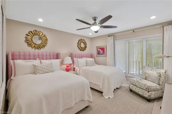 a bedroom with two beds and a couch