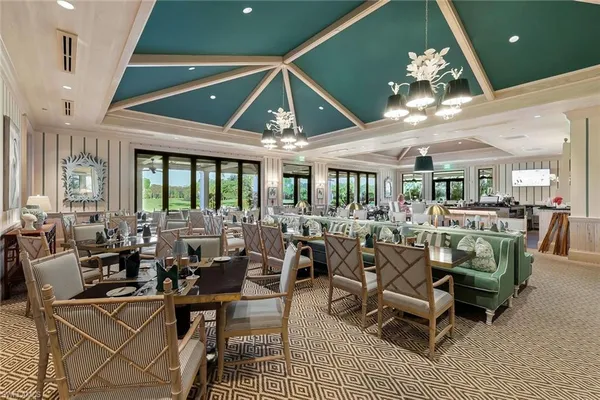 a living room with lots of furniture and a chandelier
