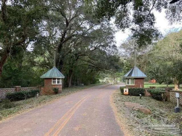 a front view of a house with a yard and tree