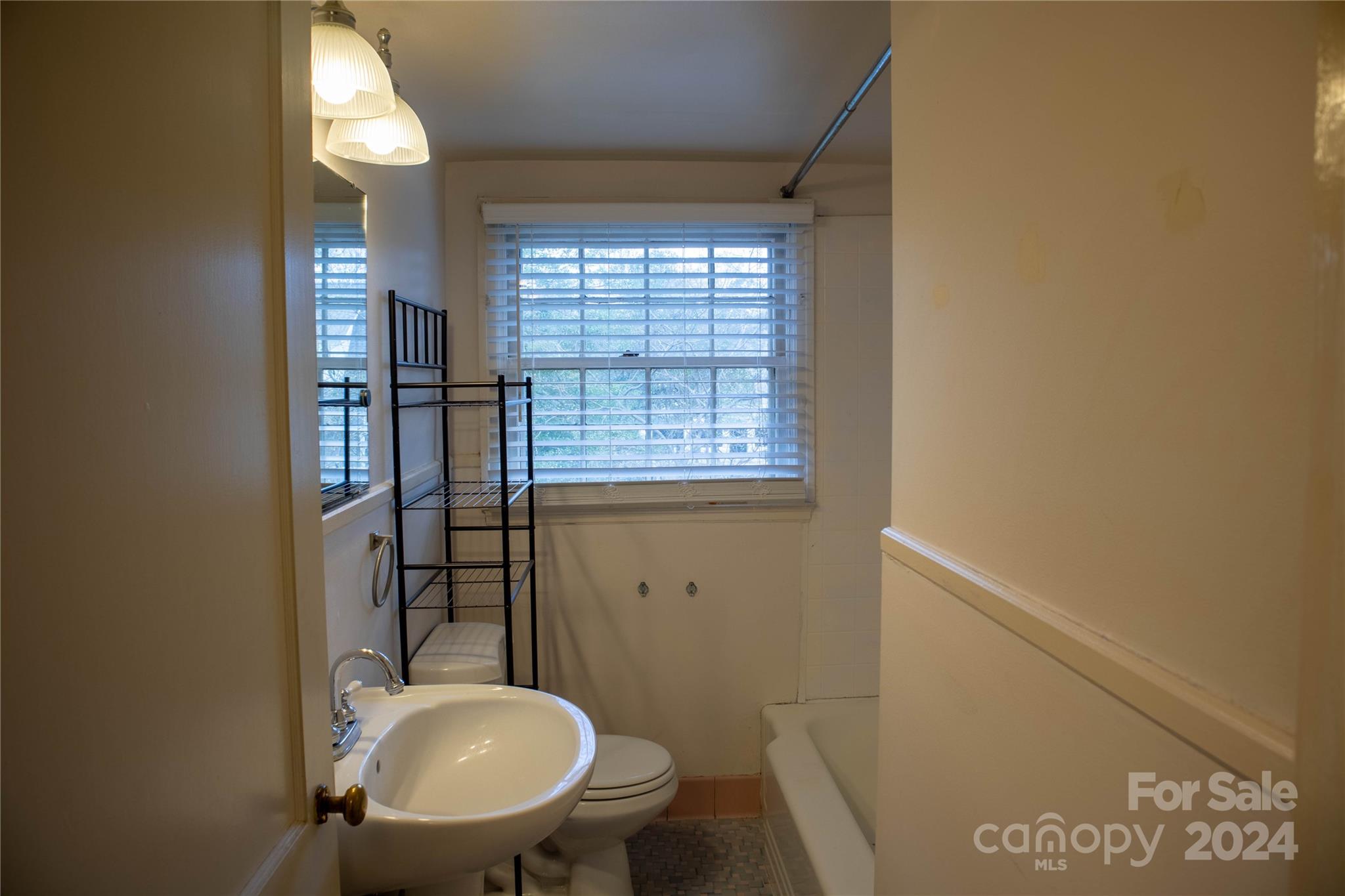 2932 Park Road Charlotte, NC 28209 - Photo 13 of 17 a bathroom with a toilet mirror and vanity