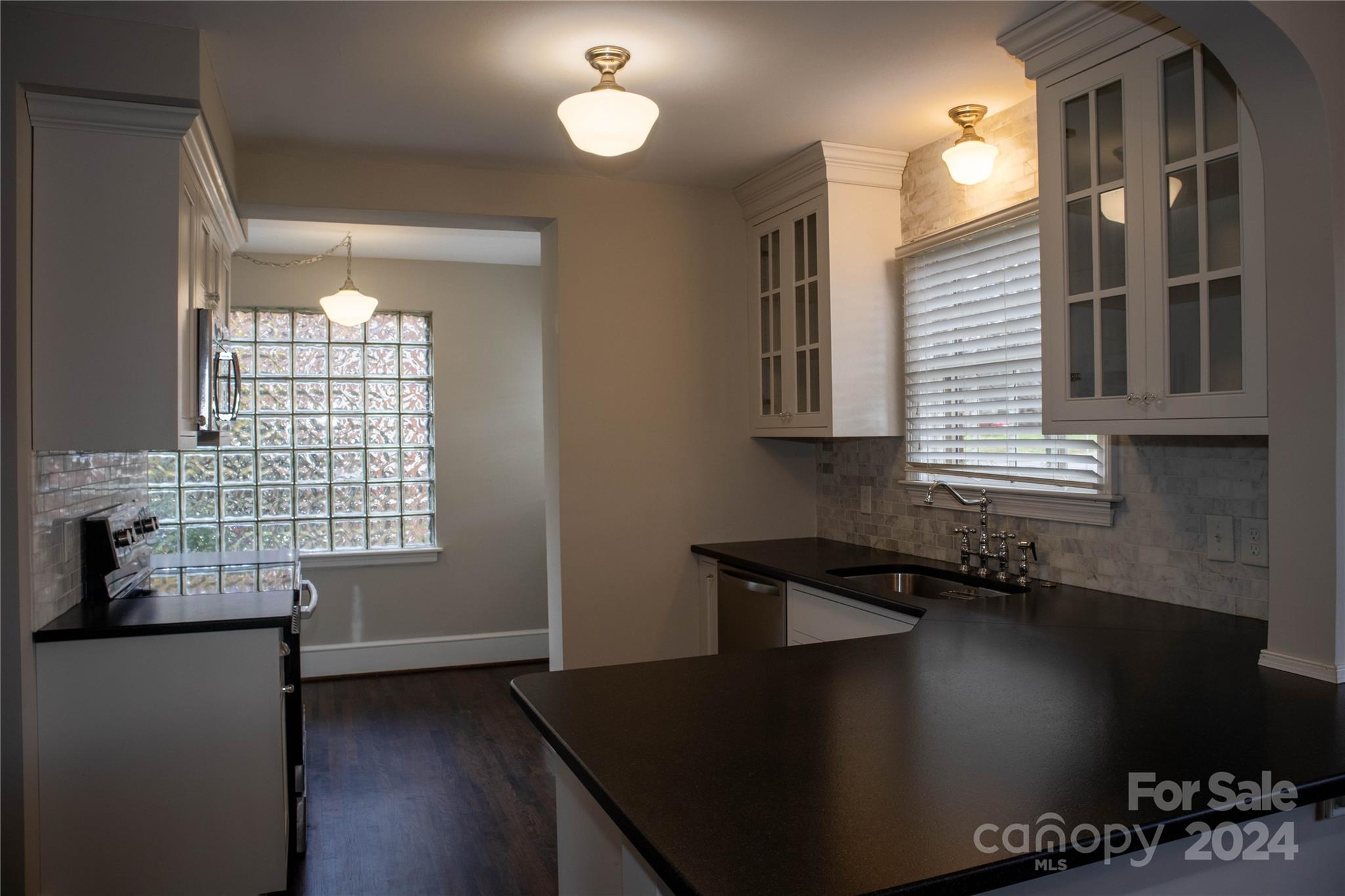 2932 Park Road Charlotte, NC 28209 - Photo 6 of 17 a kitchen with granite countertop a sink a stove and cabinets