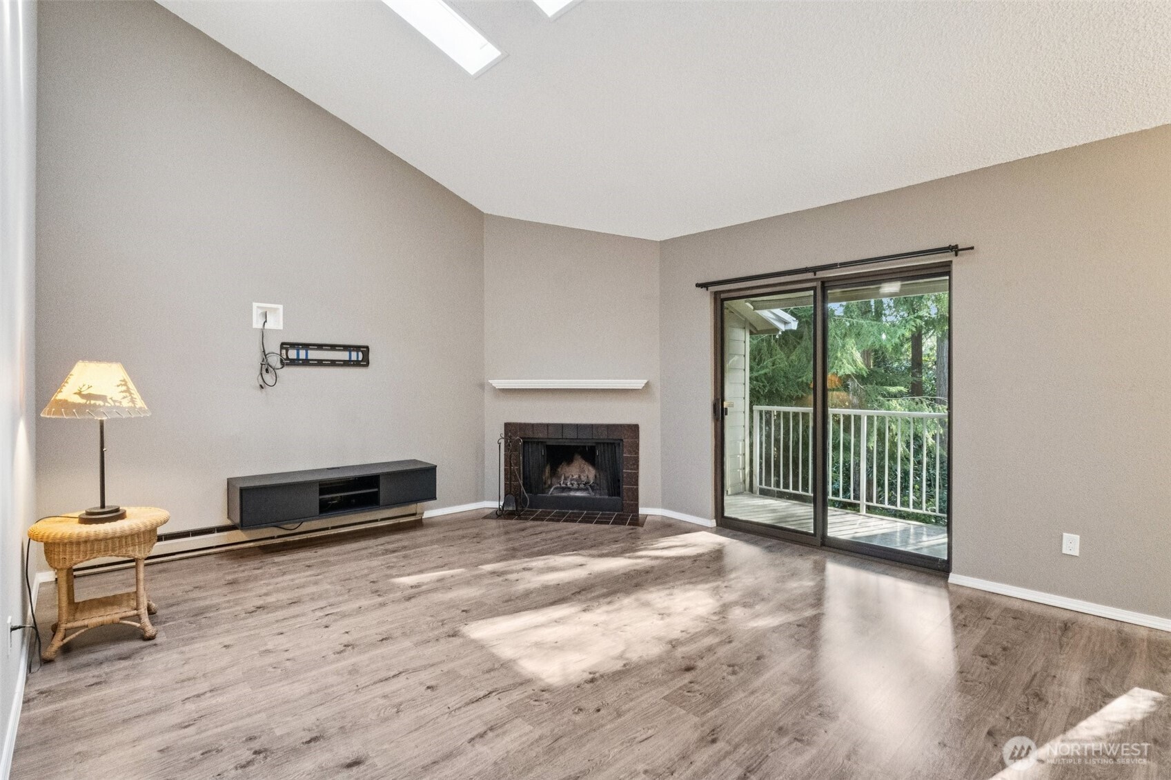 5502 220th Street Southwest, Unit D201 Mountlake Terrace, WA 98043 - Photo 3 of 19 a living room with furniture a window and a fireplace