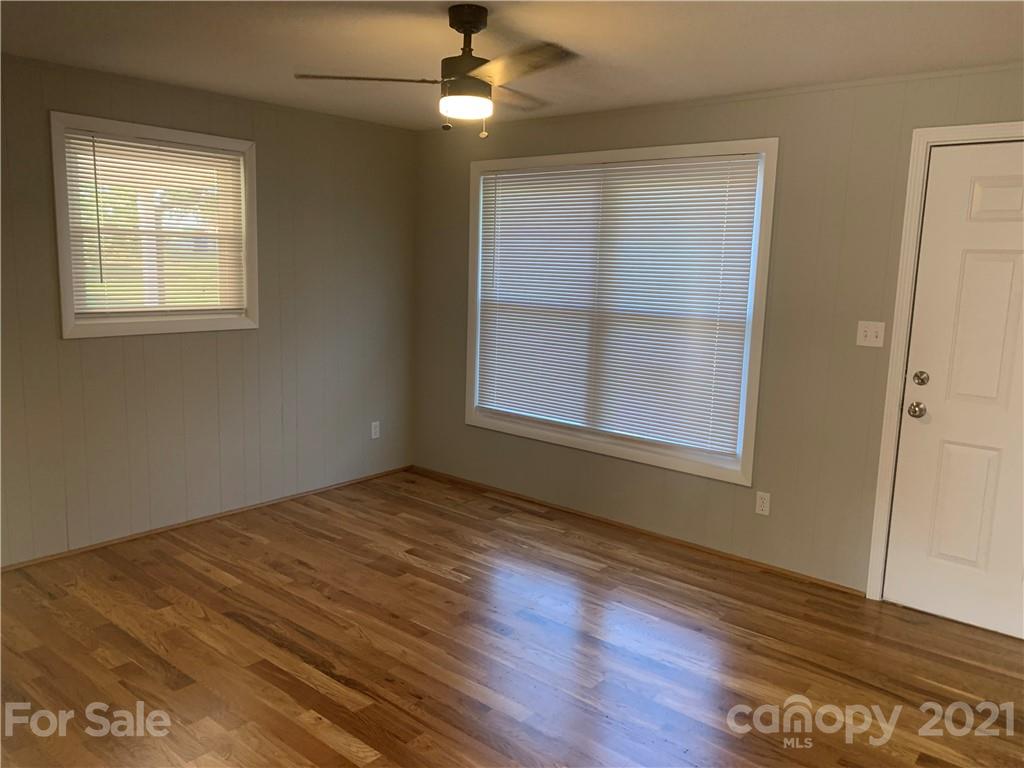 1900 Crestview Drive Newton, NC 28658 - Photo 2 of 13 a view of an empty room with wooden floor and a window