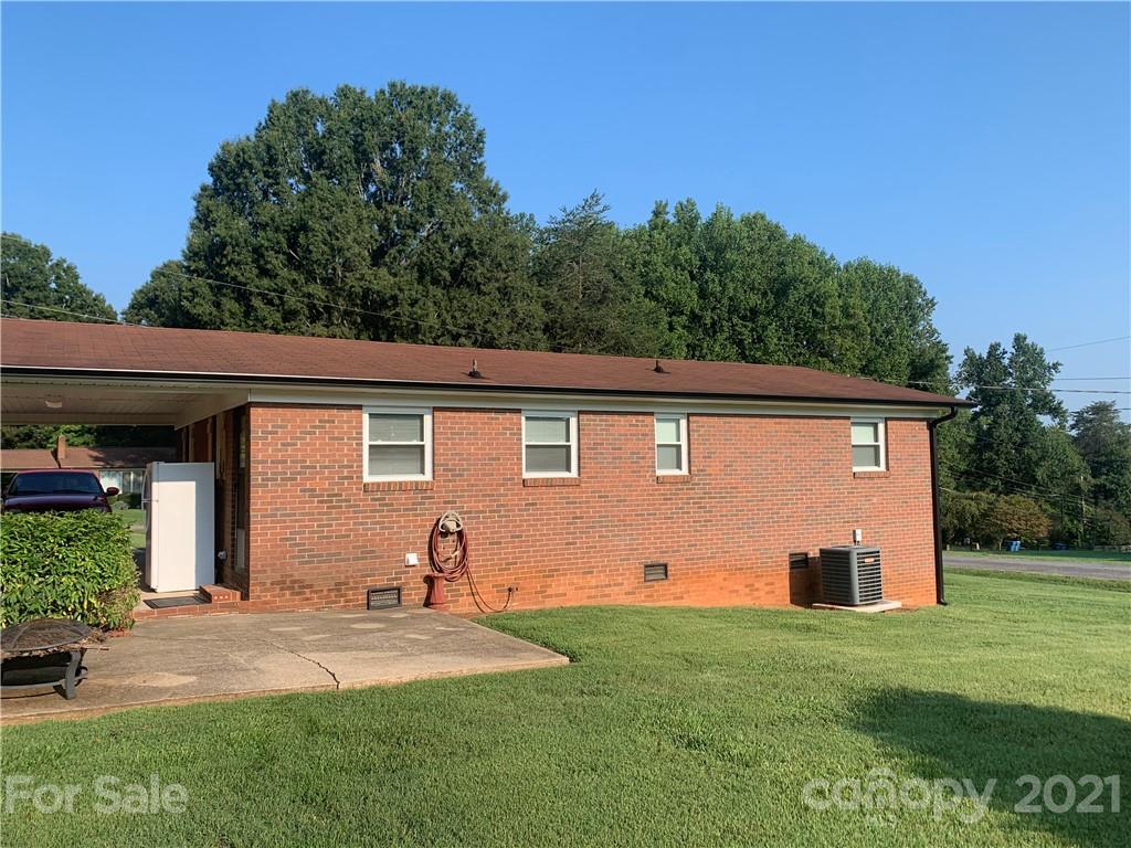 1900 Crestview Drive Newton, NC 28658 - Photo 11 of 13 a backyard of a house with plants and barbeque oven