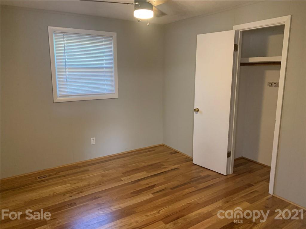 1900 Crestview Drive Newton, NC 28658 - Photo 3 of 13 a view of empty room with wooden floor and fan