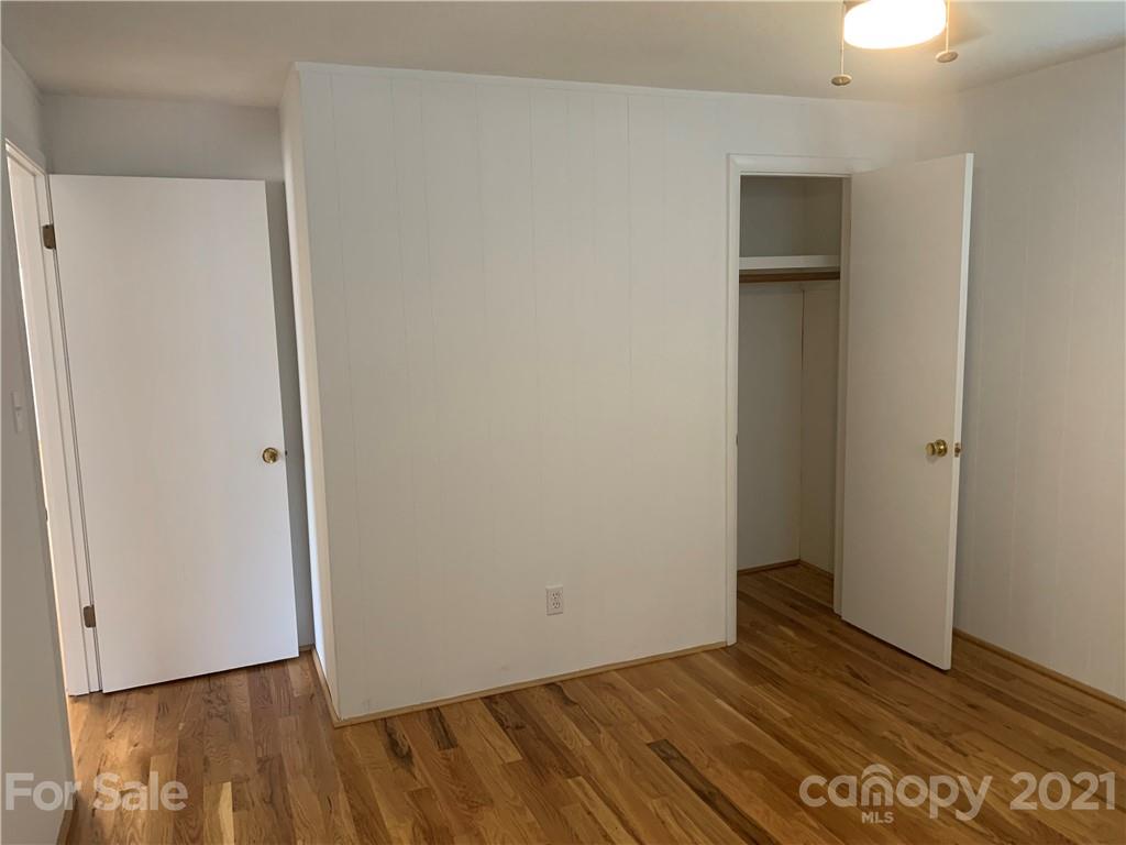1900 Crestview Drive Newton, NC 28658 - Photo 7 of 13 a view of an empty room with wooden floor and a window