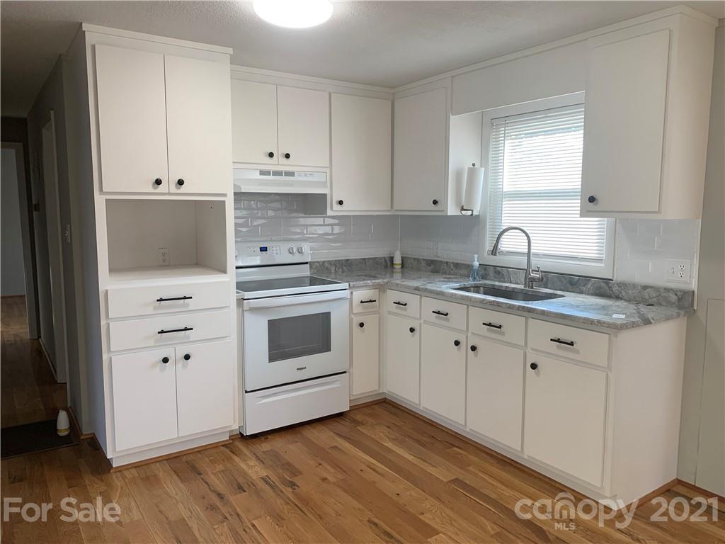 1900 Crestview Drive Newton, NC 28658 - Photo 9 of 13 a kitchen with granite countertop white cabinets and white appliances