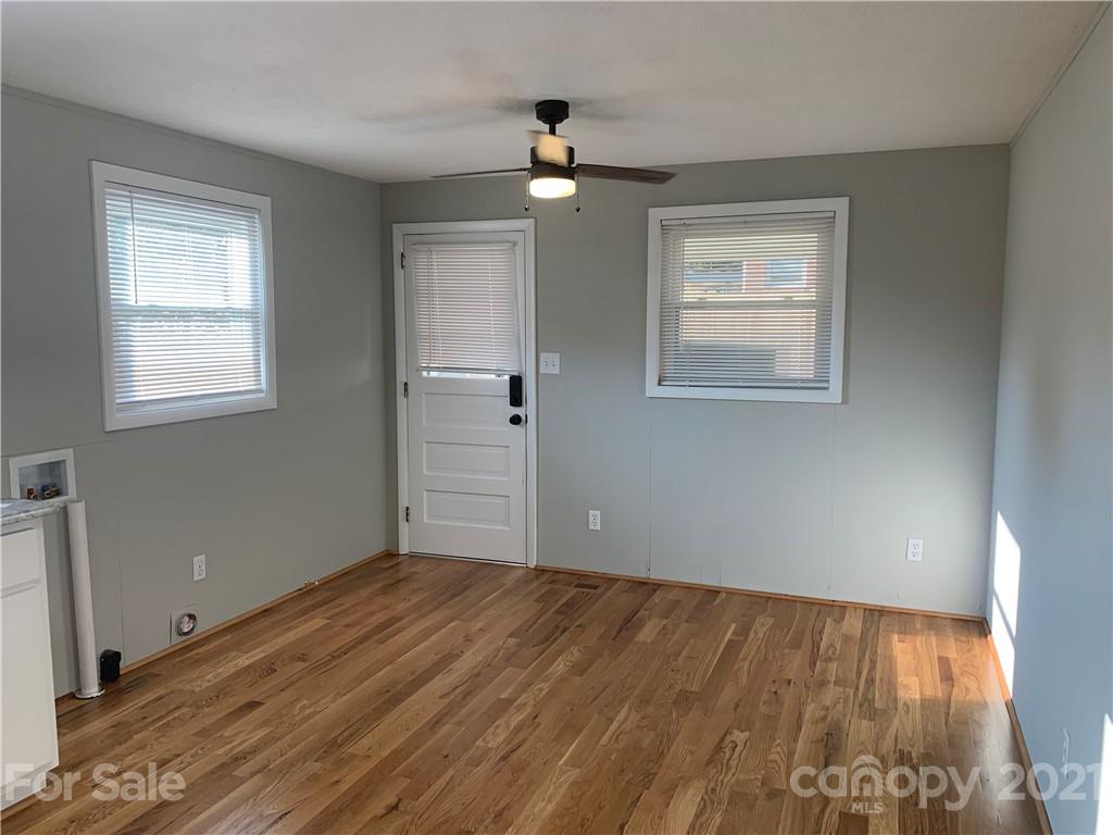 1900 Crestview Drive Newton, NC 28658 - Photo 10 of 13 a view of empty room with wooden floor and fan