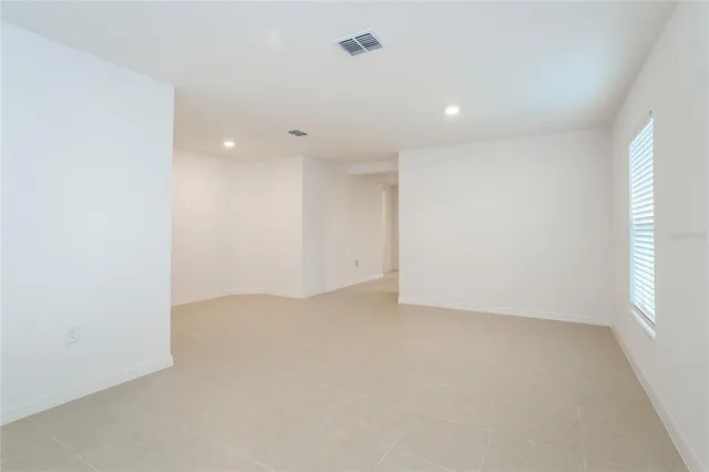 an empty room with a empty space and windows