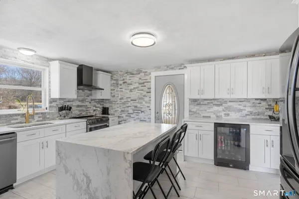 a view of living room kitchen with stainless steel appliances cabinets