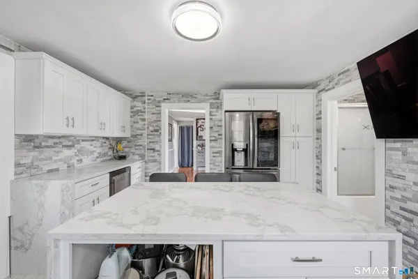 a kitchen with stainless steel appliances granite countertop a sink and a microwave