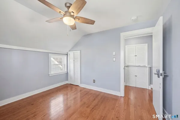 a view of a bedroom with furniture and wooden floor