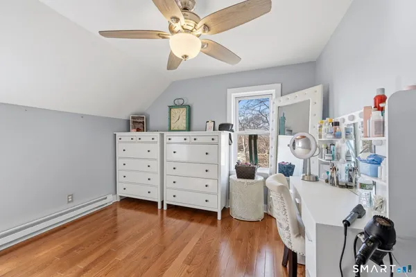 a view of a livingroom with furniture and a ceiling fan