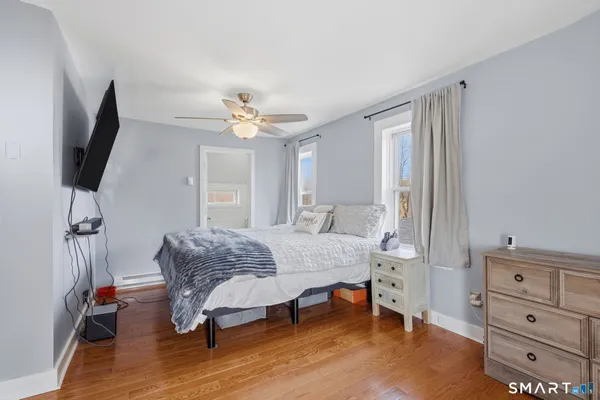 a bedroom with a bed and a flat screen tv
