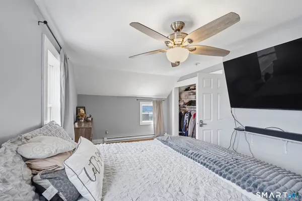 a view of a bedroom with a bed and a tv