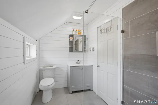 a bathroom with a shower and a sink