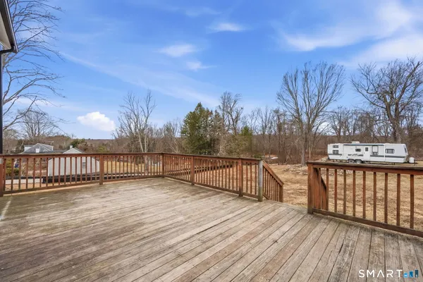 a view of a terrace with wooden floor and fence