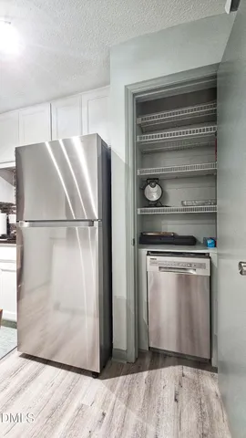 a kitchen with a refrigerator and a stove