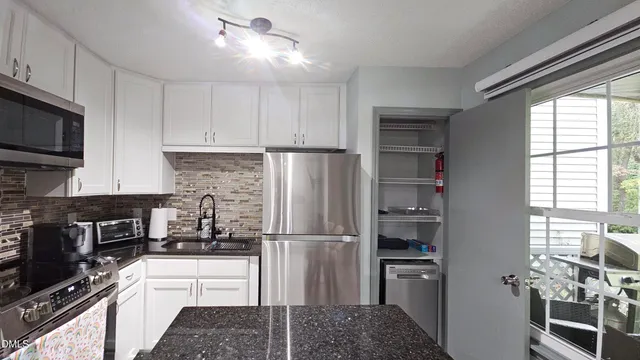 a kitchen with a refrigerator stove and microwave