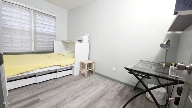 a view of a workspace with furniture and a window