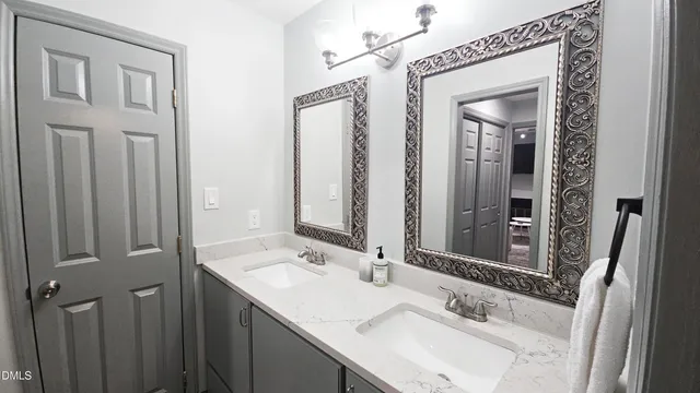 a bathroom with a sink double vanity and a mirror