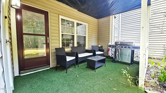 a view of a house with backyard and a patio
