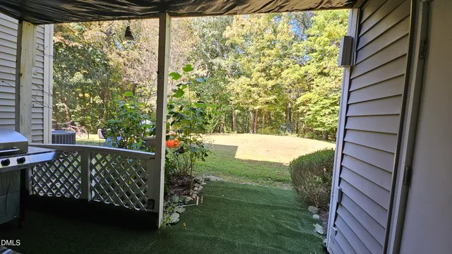 a view of a balcony with yard
